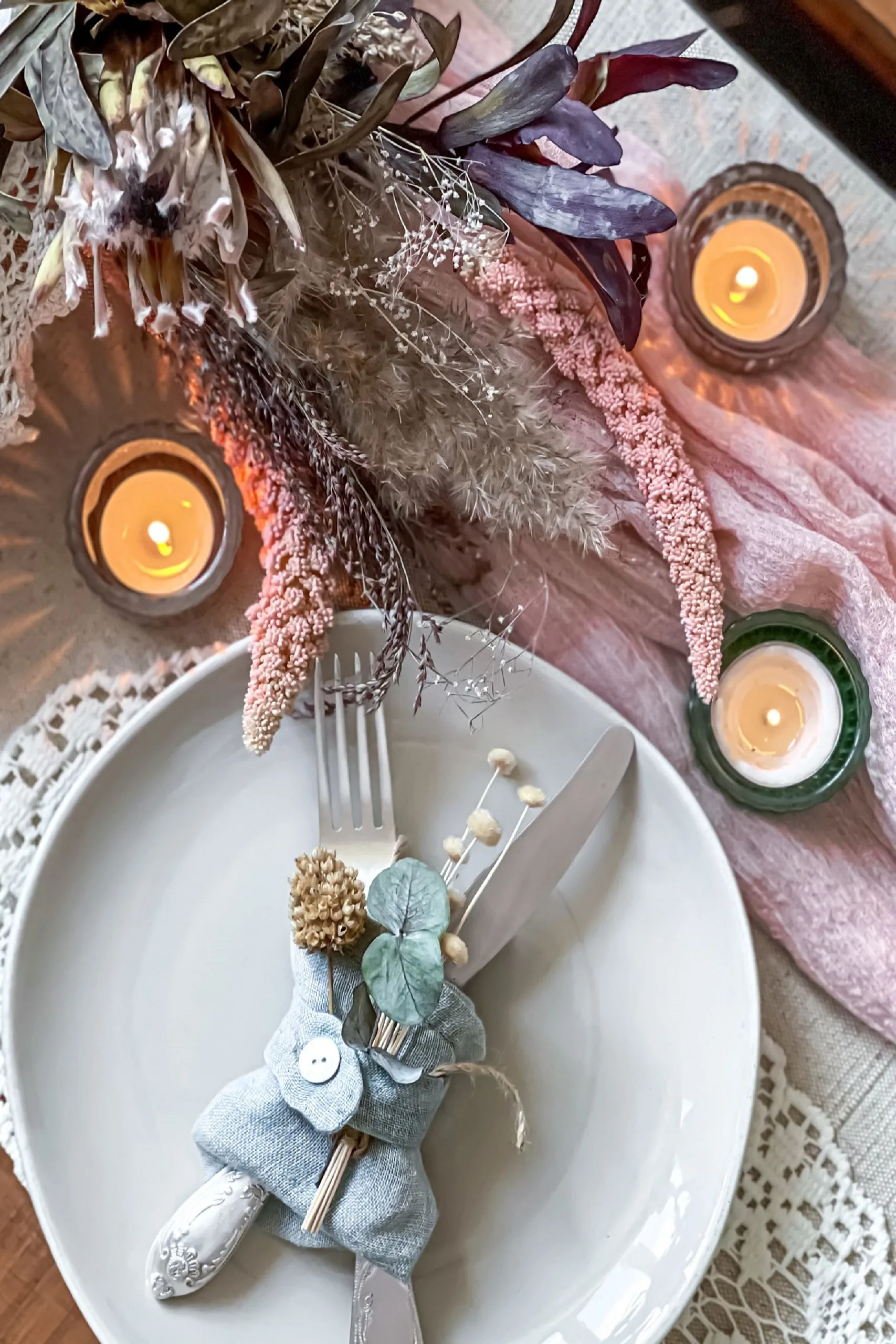 Table setting for a romantic dinner, wedding or any occasion with candles and dried flowers as decor.